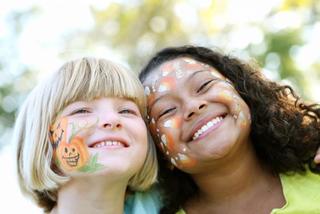 Two young girls with fall-themed face paintings at one of the fall festivals in Myrtle Beach.