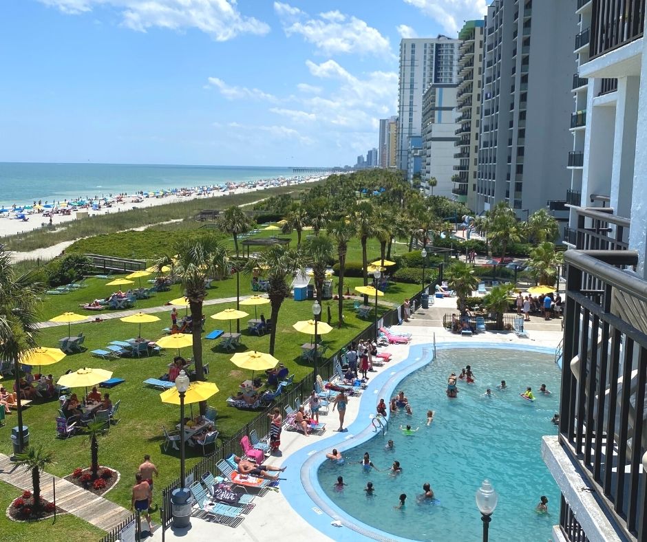 Balcony view of oceanfront lawn and pool at Dayton House