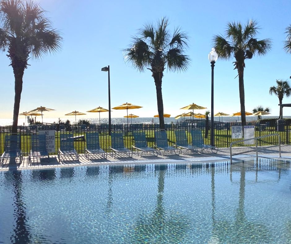 Dayton House Resort's zero-entry oceanfront pool and yellow umbrella lawn