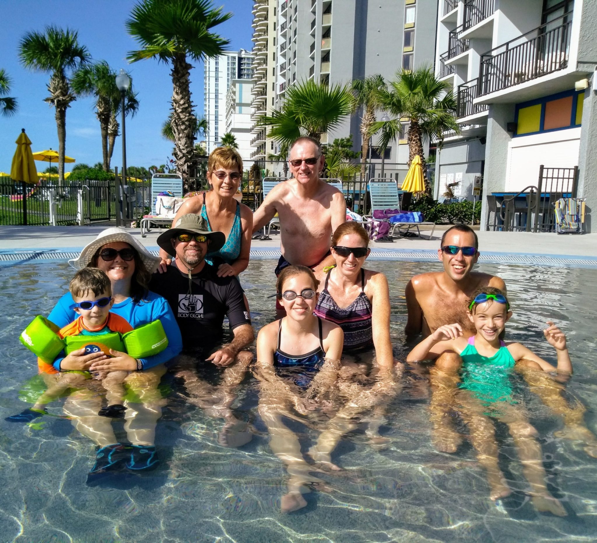 family swimming in pool