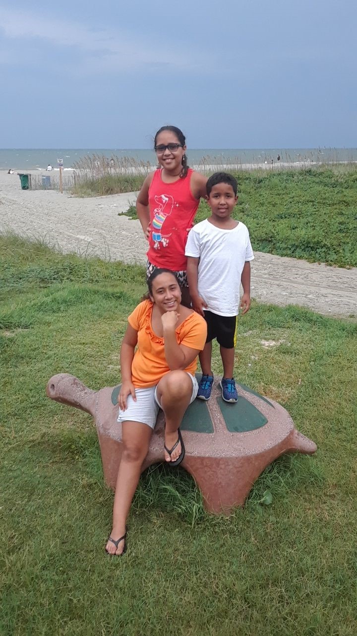 kids standing on turtle