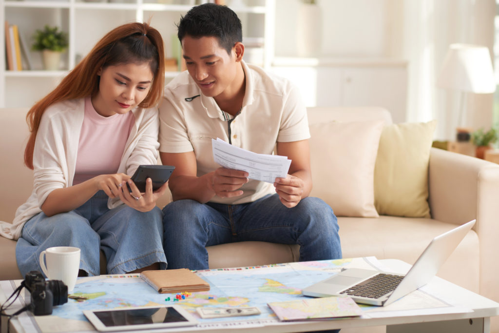 A couple reviewing their beach vacation checklist.